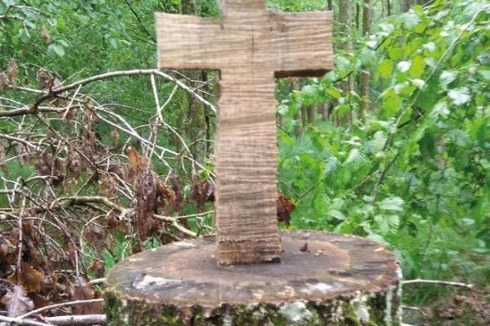 Holzkreuz im Wald